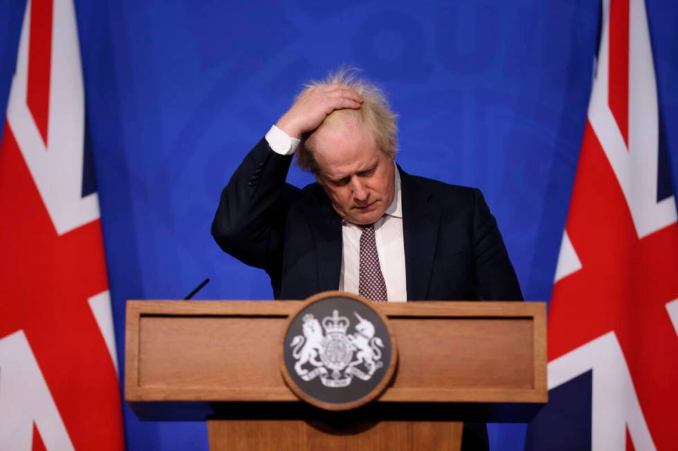 Britain's Prime Minister Boris Johnson gestures as he speaks during a press conference in Londo ...