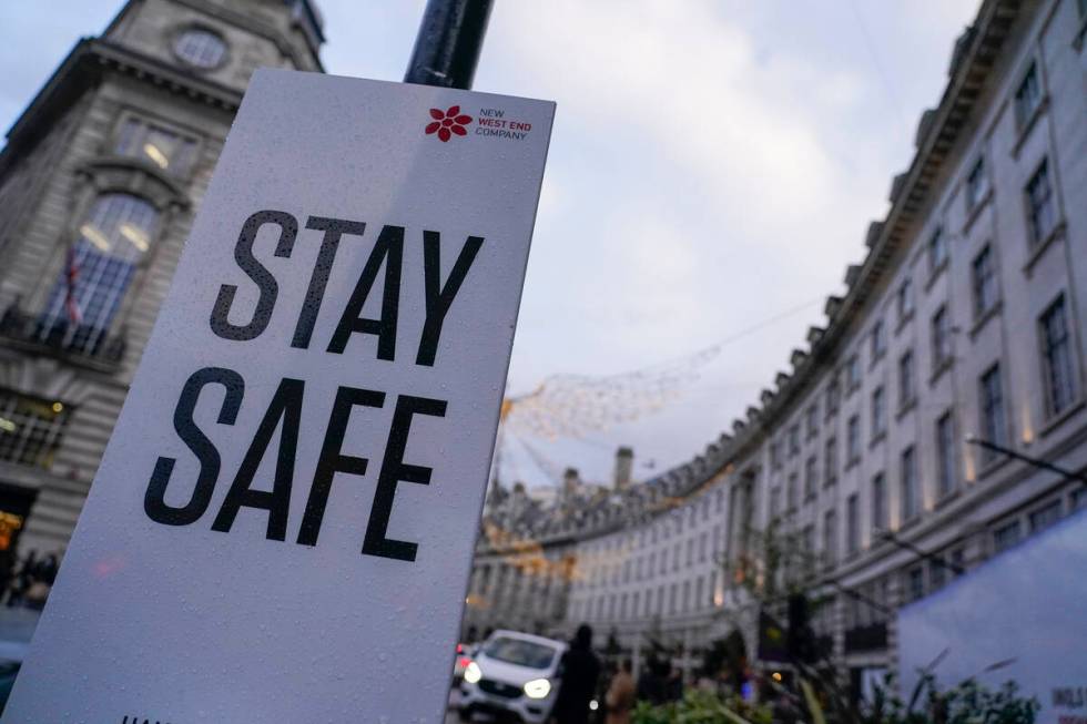 A sign reading 'Stay safe' in Regent Street, in London, Friday, Nov. 26, 2021. A slew of nation ...