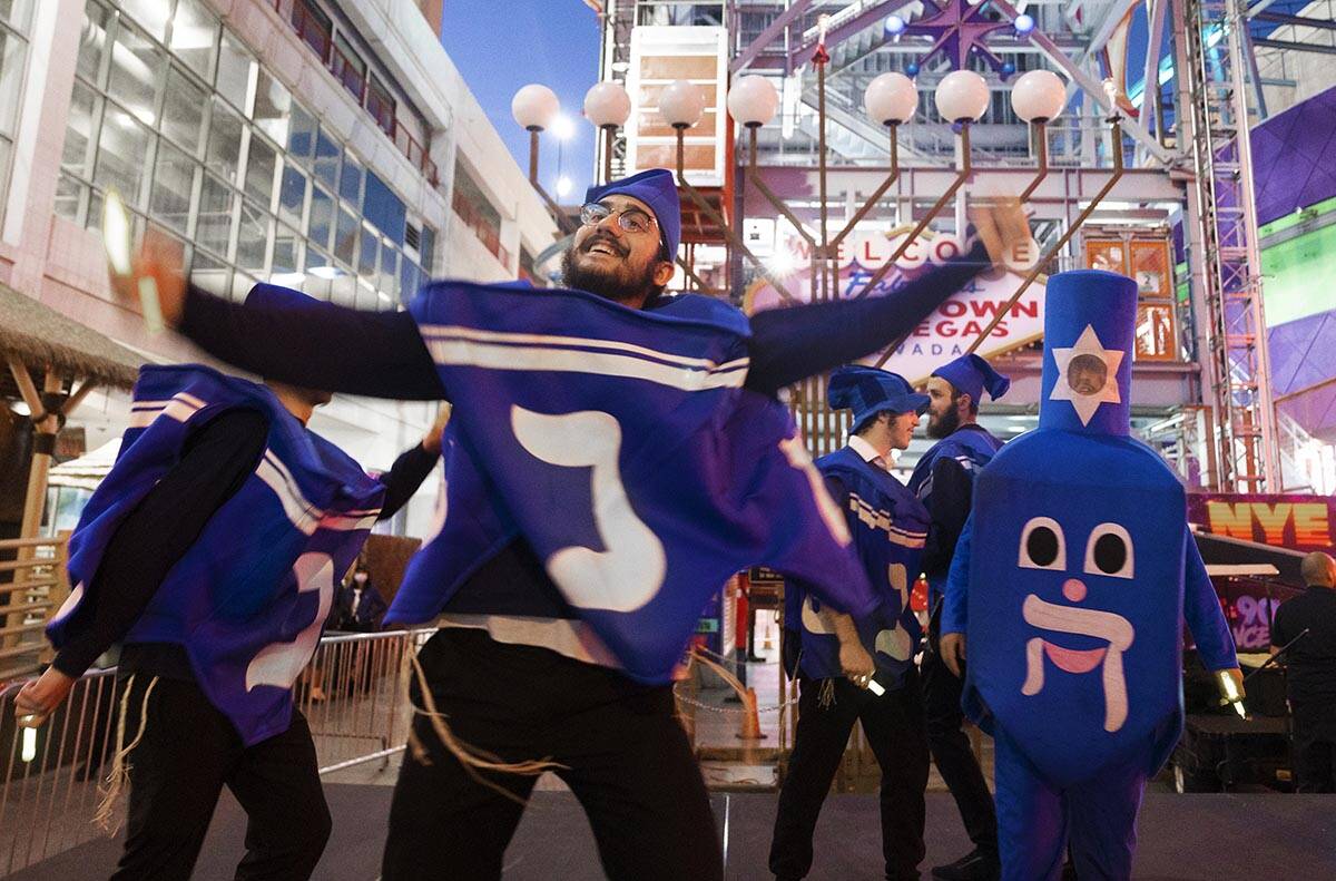 The Dancing Dreidels entertain the crowd during an event celebrating the first night of Hanukka ...