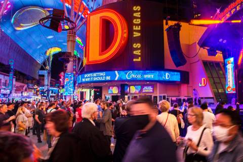 People walk past D Las Vegas on Fremont Street on Wednesday, Oct. 20, 2021, in Las Vegas. (Benj ...