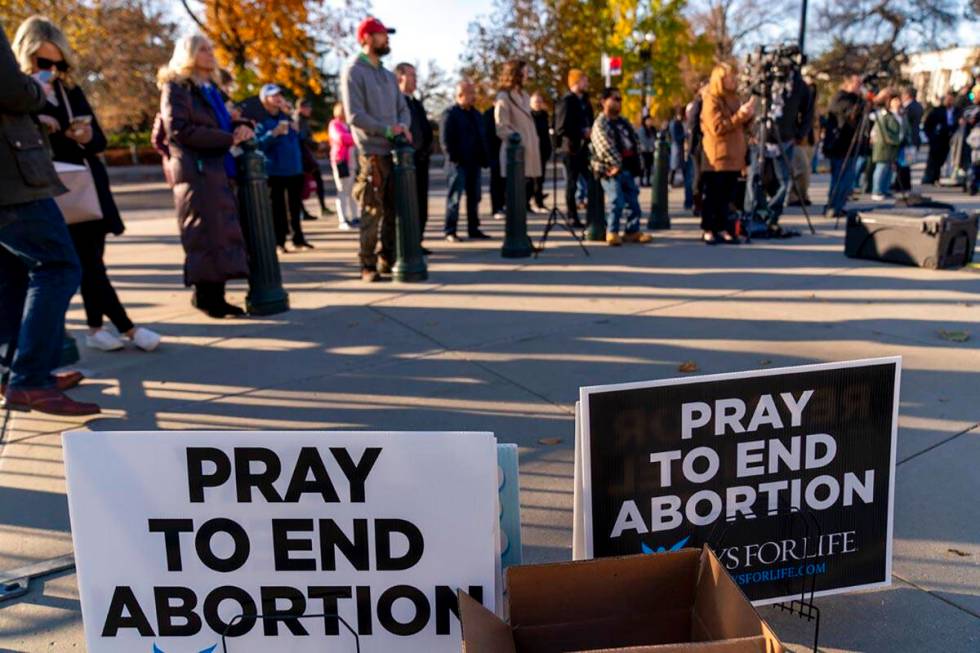 People listen during an anti-abortion rally outside of the Supreme Court in Washington, Tuesday ...