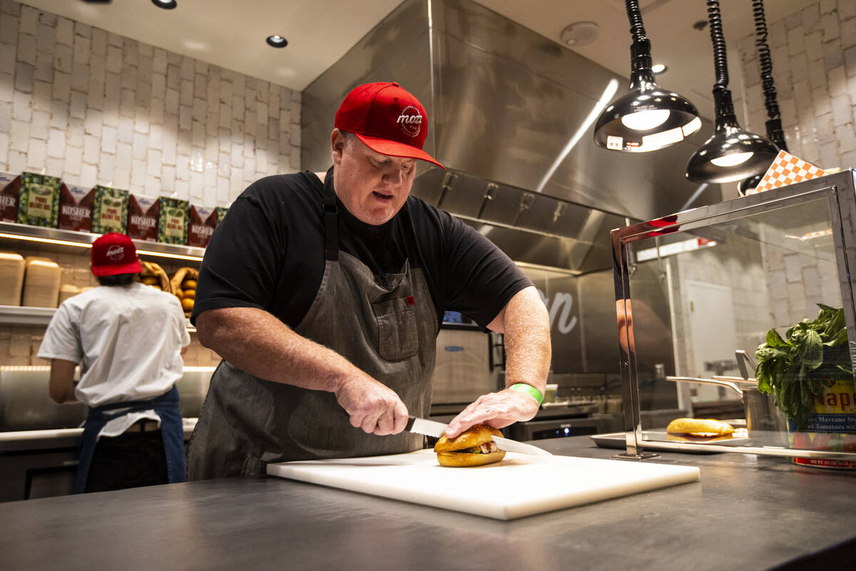 Chef James Trees prepares a chicken parmesan sandwich at Mozz, inside of the Famous Foods Stree ...