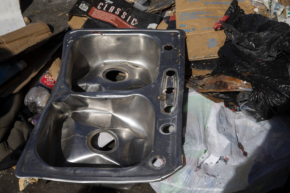 A sink that someone tried to recycle is among the trash in Ҵhe pileӠat Republic Ser ...