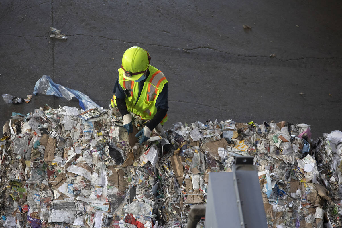 An employee sifts through recycled materials at Republic Services on Friday, Oct. 22, 2021, in ...
