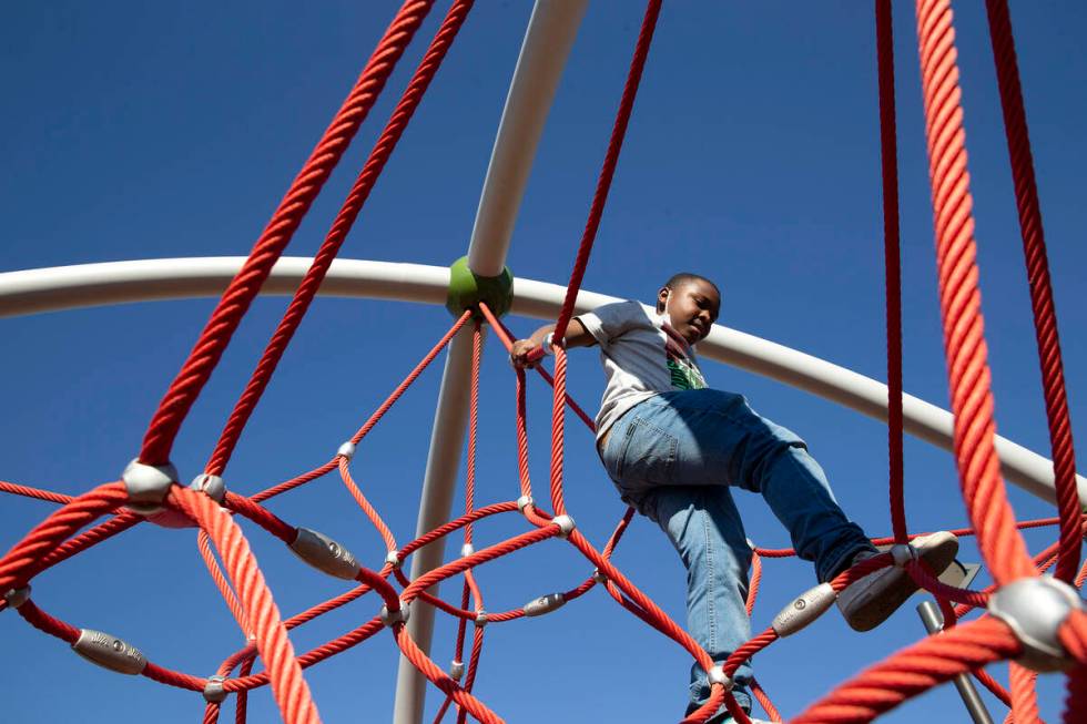 Jamir Harold, 8, climbs on the play structure at the new Historic Westside Legacy Park on Satur ...