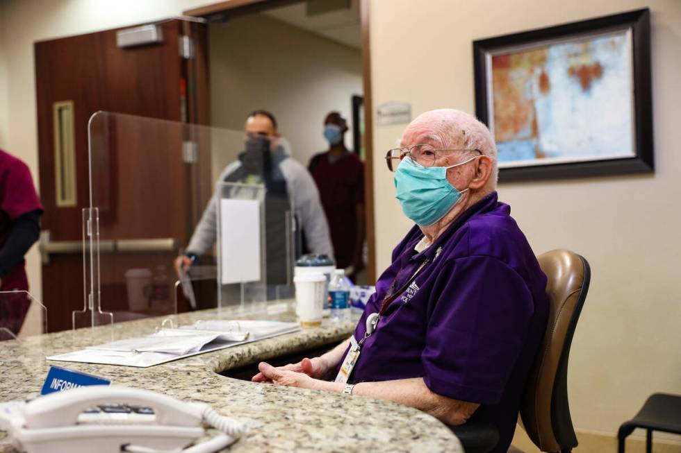 Ernie Hernandez, a longtime hospital volunteer, stands his post at the information desk where h ...