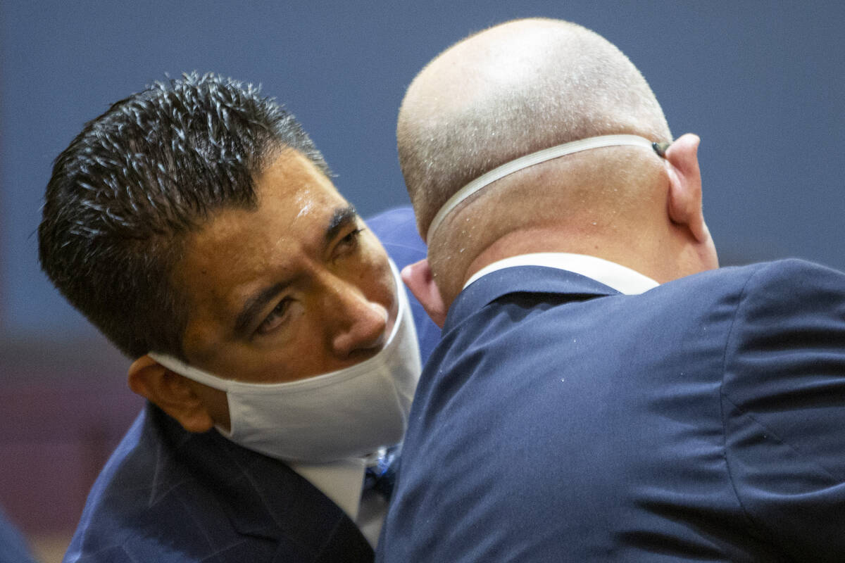 Alpine Motel Apartments owner Adolfo Orozco speaks to his attorney Dominic Gentile during a con ...