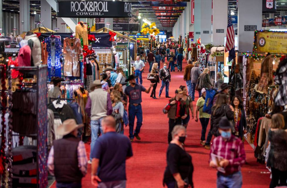 Shoppers make their way up a main aisle during the opening night of the Cowboy Channel Cowboy C ...