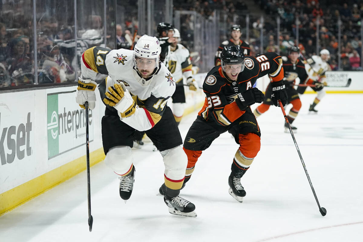 Vegas Golden Knights' Nicolas Hague, left, skates past Anaheim Ducks' Jakob Silfverberg while c ...