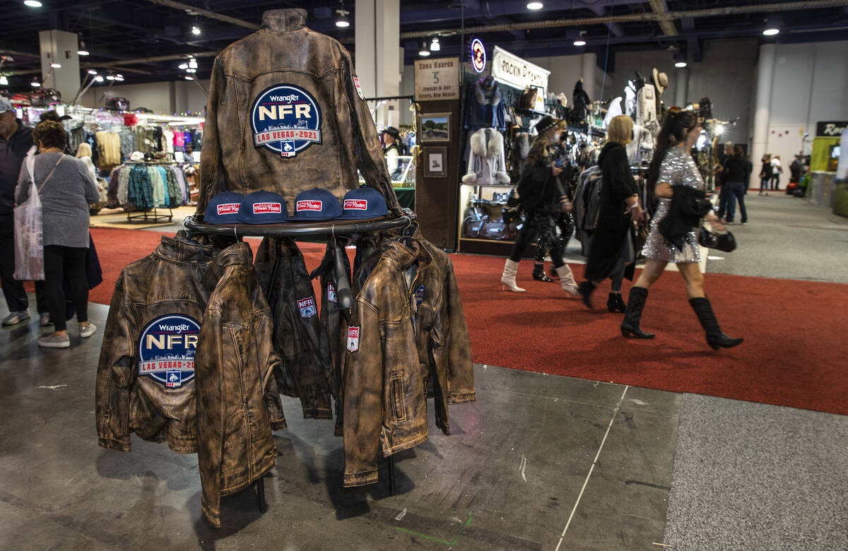 Shoppers make their way up a main aisle during the opening night of the Cowboy Channel Cowboy C ...