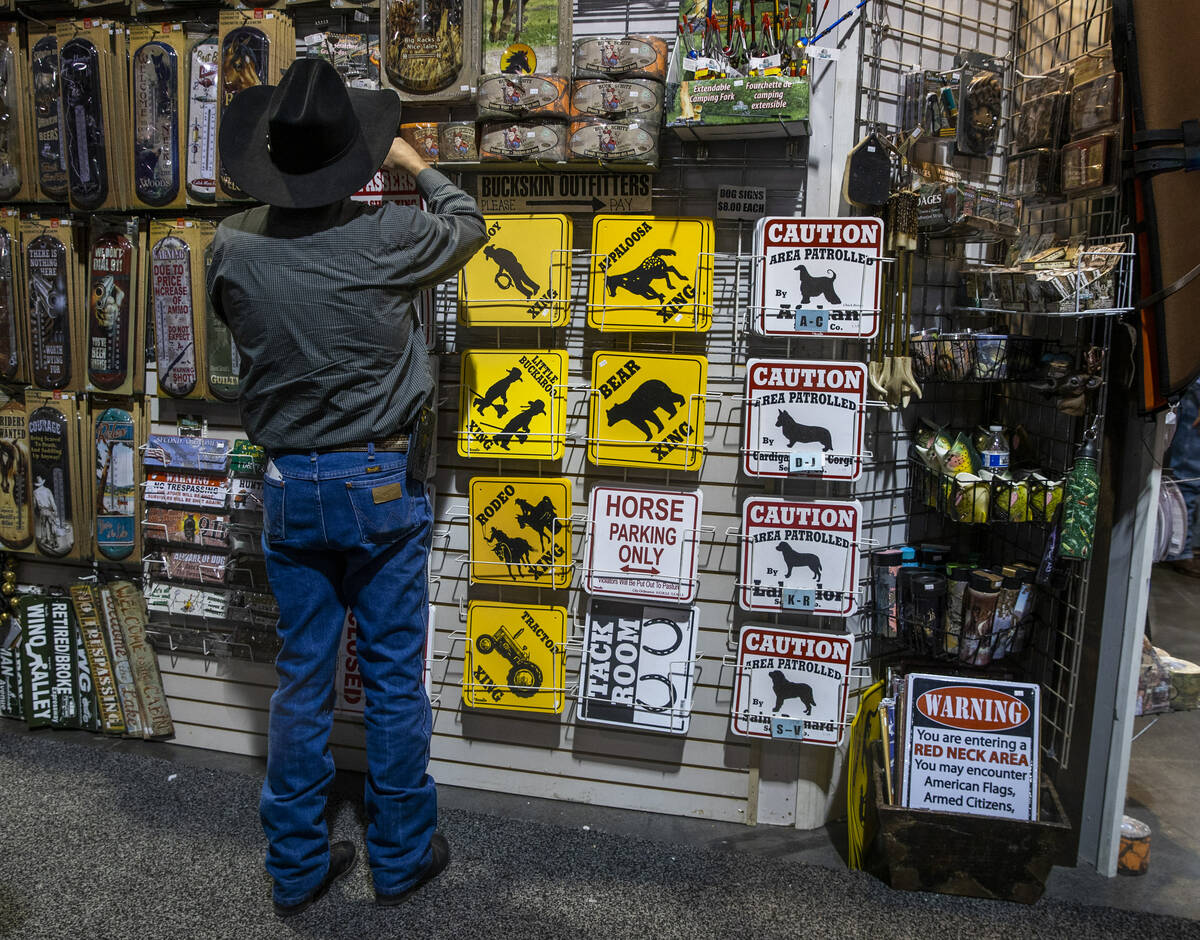 A shopper checks out some of the merchandise during the opening night of the Cowboy Channel Cow ...