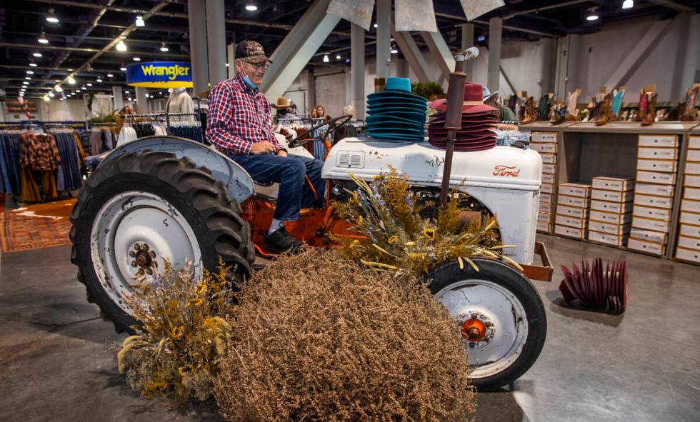 Larry Reed of Greensburgh, PA., sits on an old tractor as part of a display during the opening ...
