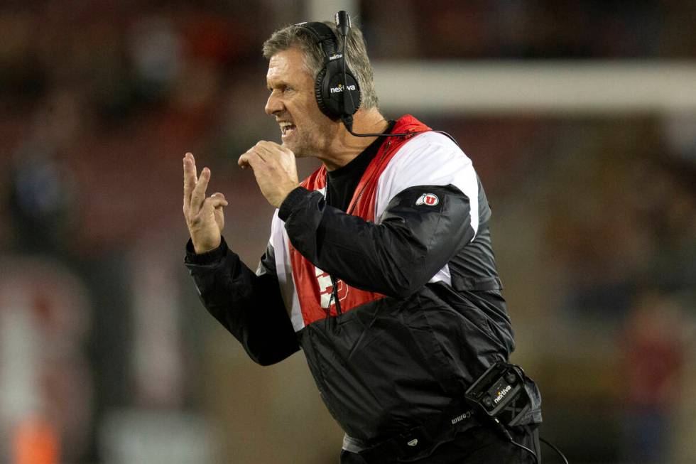 Utah head coach Kyle Whittingham signals a play to his team during the second quarter of an NCA ...