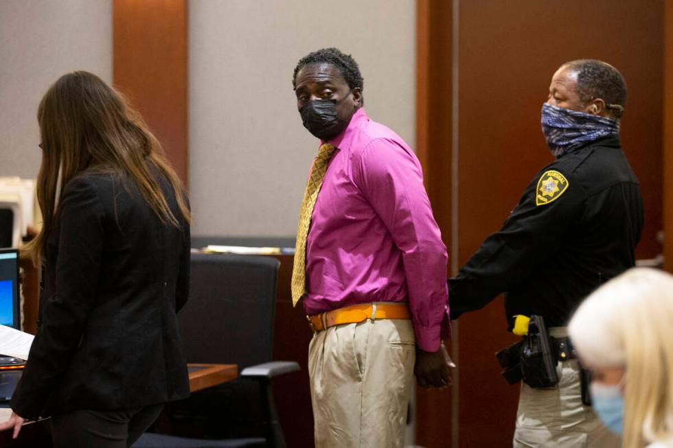Leroy Mack, who shot his ex-girlfriend Rayven Thomas, looks back at her after being sentenced i ...