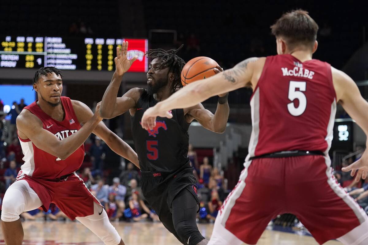 UNLV guard Michael Nuga (1) and guard Jordan McCabe (5) defend as SMU guard Emmanuel Bandoumel ...