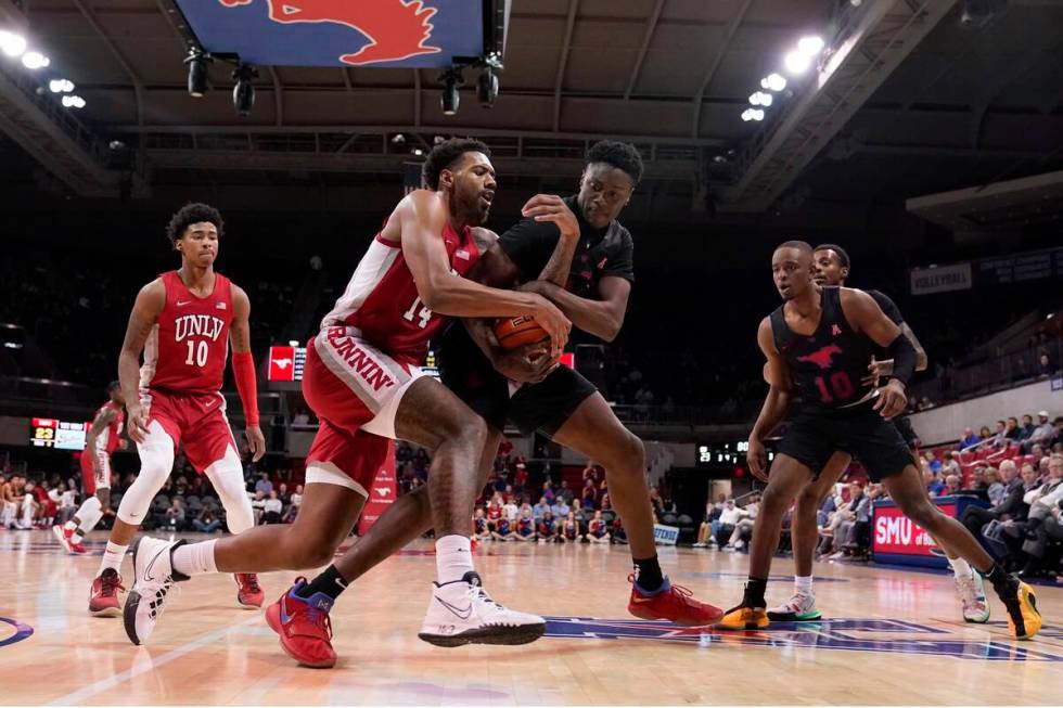 UNLV forward Royce Hamm Jr. (14) and SMU forward Jahmar Young Jr., center right, compete for co ...