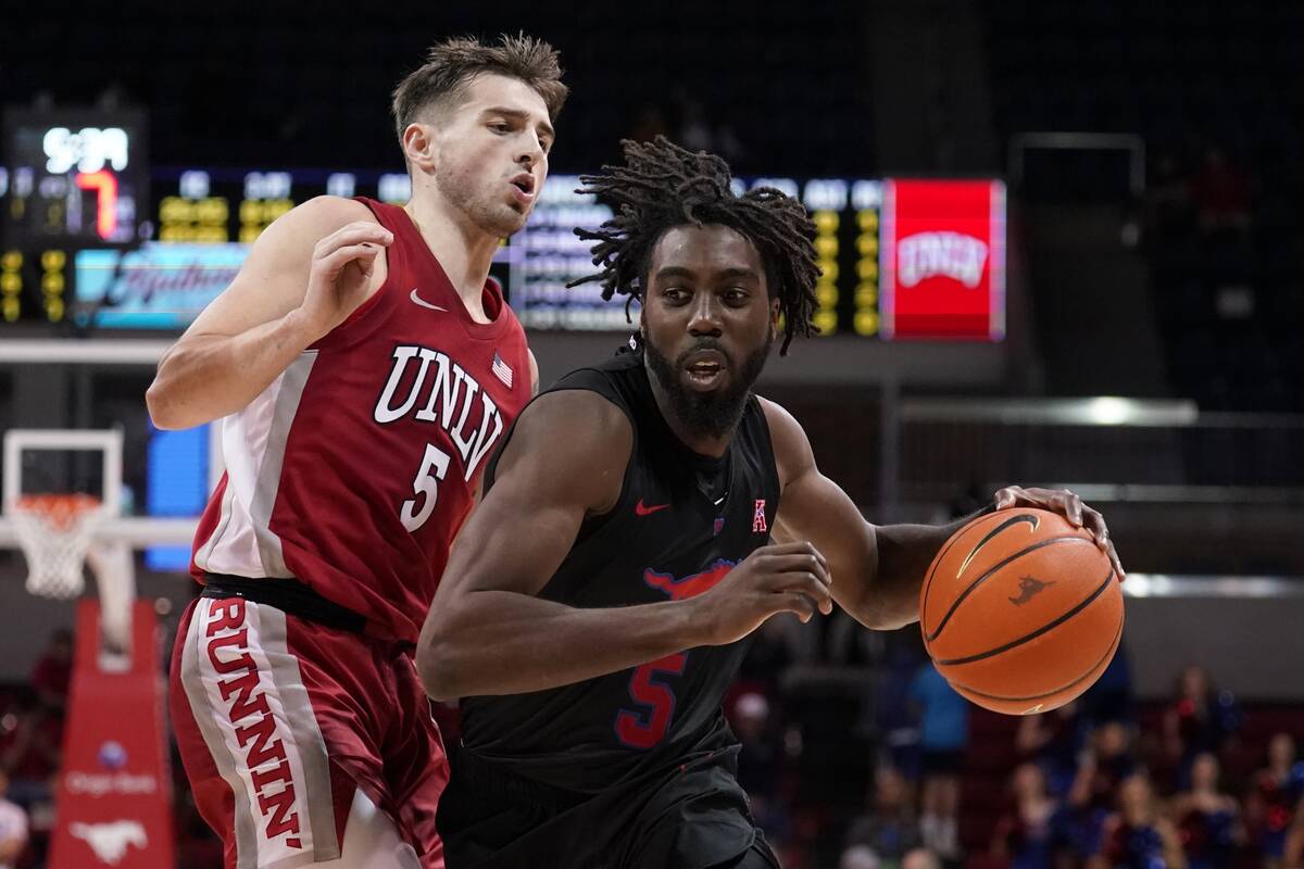 UNLV guard Jordan McCabe, left, defends as SMU guard Emmanuel Bandoumel, right, works to the ba ...