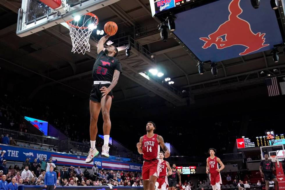 SMU guard Michael Weathers (23) leaps to the basket to dunk after getting past UNLV forward Roy ...