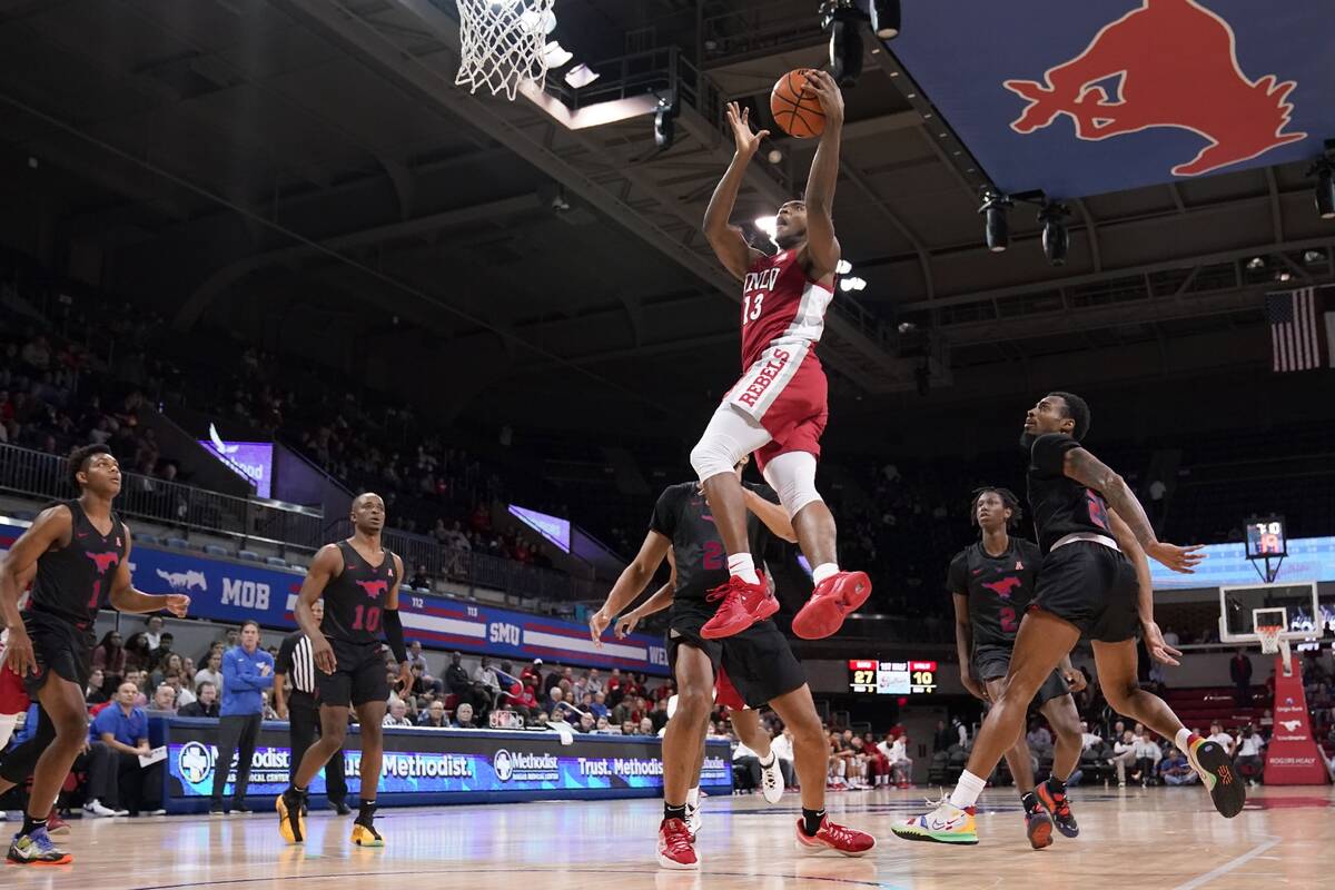 UNLV guard Bryce Hamilton (13) goes up for a shot after getting through SMU defenders Zhuric Ph ...