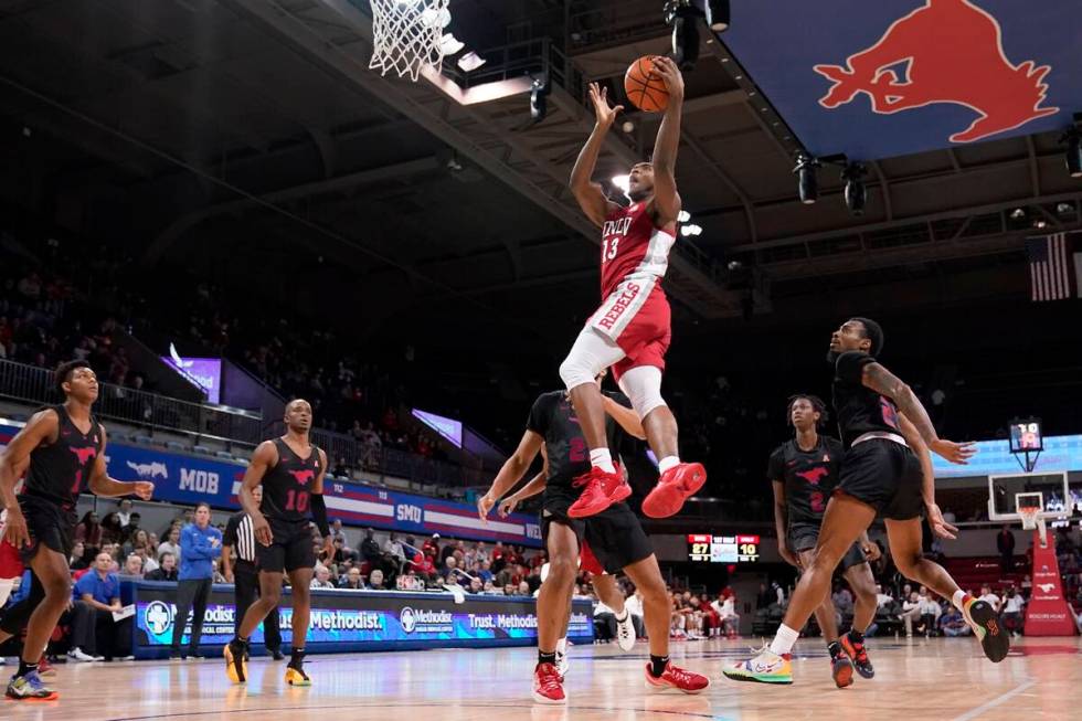 UNLV guard Bryce Hamilton (13) goes up for a shot after getting through SMU defenders Zhuric Ph ...