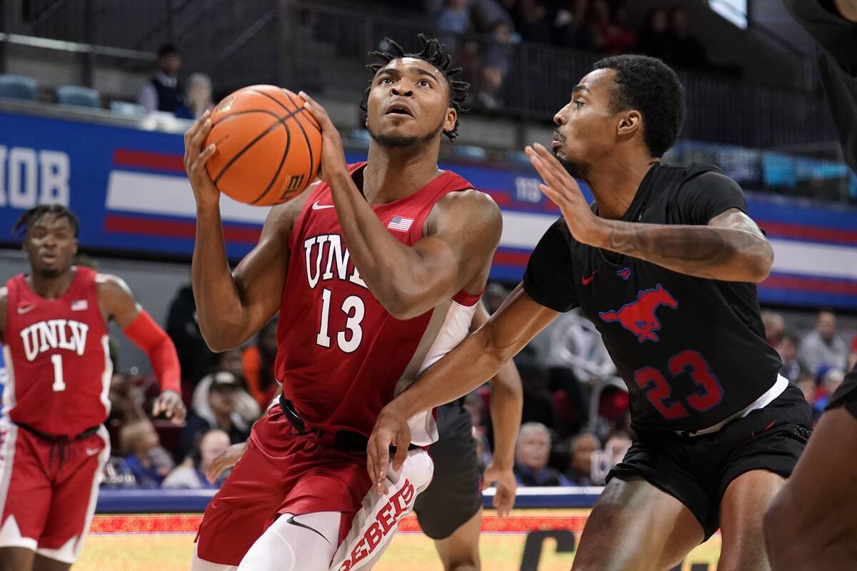 UNLV guard Bryce Hamilton (13) drives to the basket for a shot as SMU guard Michael Weathers (2 ...