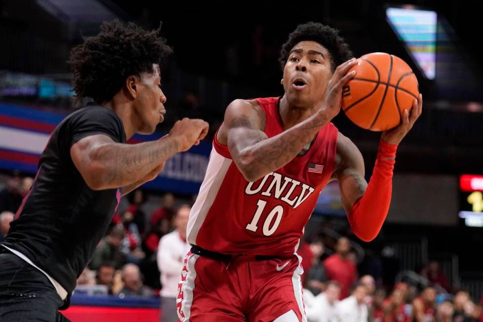 SMU guard Kendric Davis, left, defends as UNLV guard Keshon Gilbert (10) positions for a shot i ...