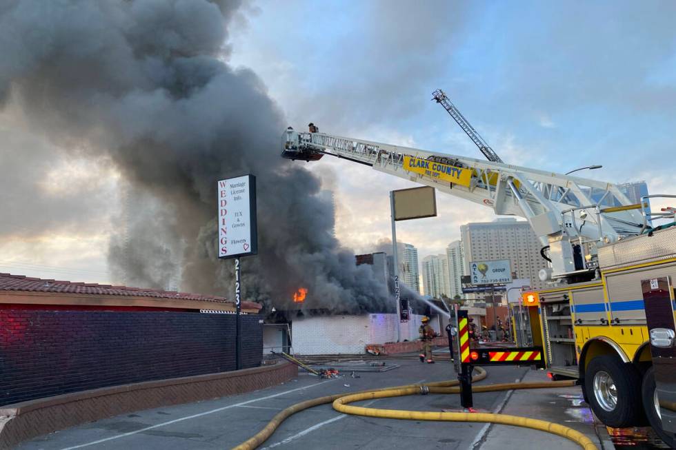 Firefighters put out a fire at 2127 Paradise Road in Las Vegas, Thursday, Dec. 2, 2021. (Glenn ...