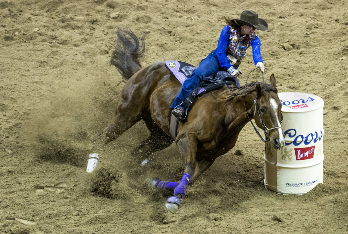 Amanda Welsch of Gillette, WY., rounds an obstacle in Barrel Racing to tie for first place duri ...
