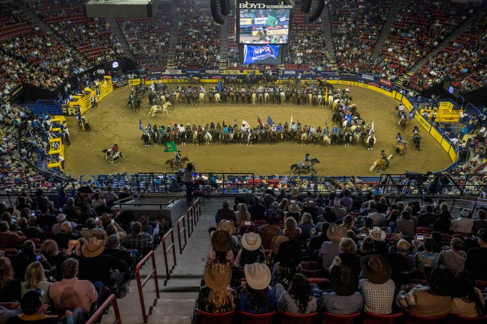 Competitors gather in the arena as the fans applaud at the start of the opening night of Wrangl ...