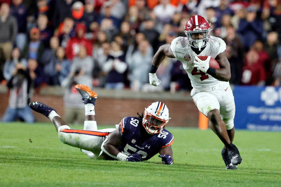Alabama running back Brian Robinson Jr. (4) carries the ball against Auburn during the second h ...