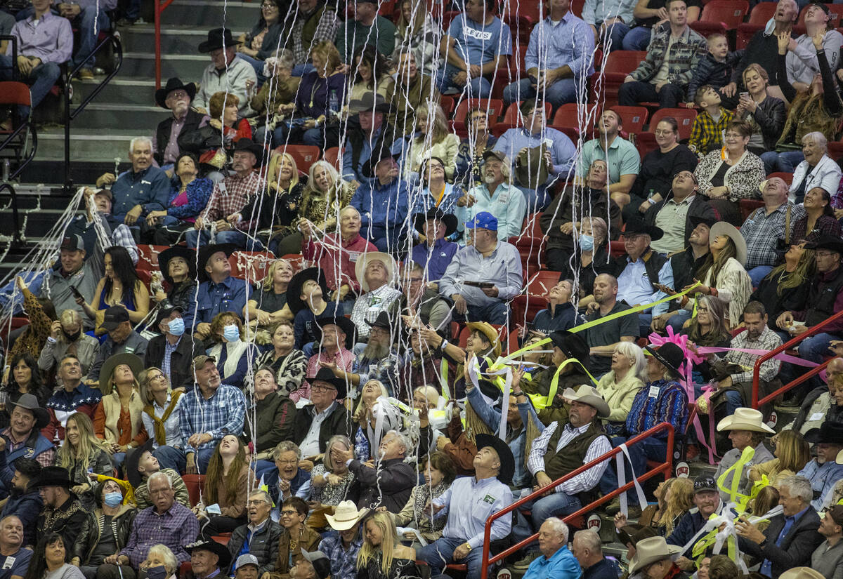 Fans are showered with confetti by the Blue Man Group during the opening night of Wrangler Nati ...