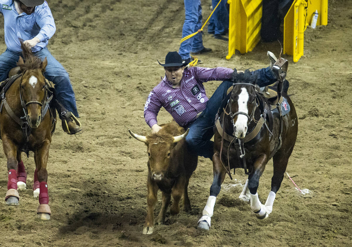 Riley Duvall of Checotah, OK., leaves his horse in Steer Wrestling to tie for first place durin ...