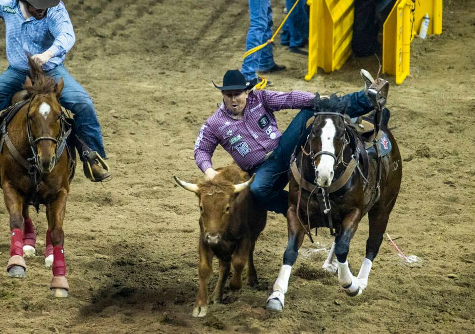 Riley Duvall of Checotah, OK., leaves his horse in Steer Wrestling to tie for first place durin ...