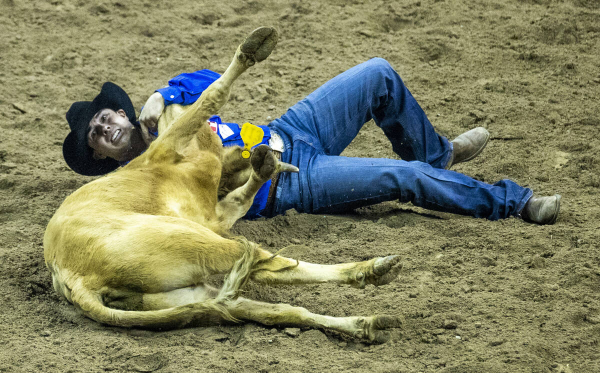 Dirk Tavenner of Rigby, ID., takes down a steer in Steer Wrestling to tie for first place durin ...