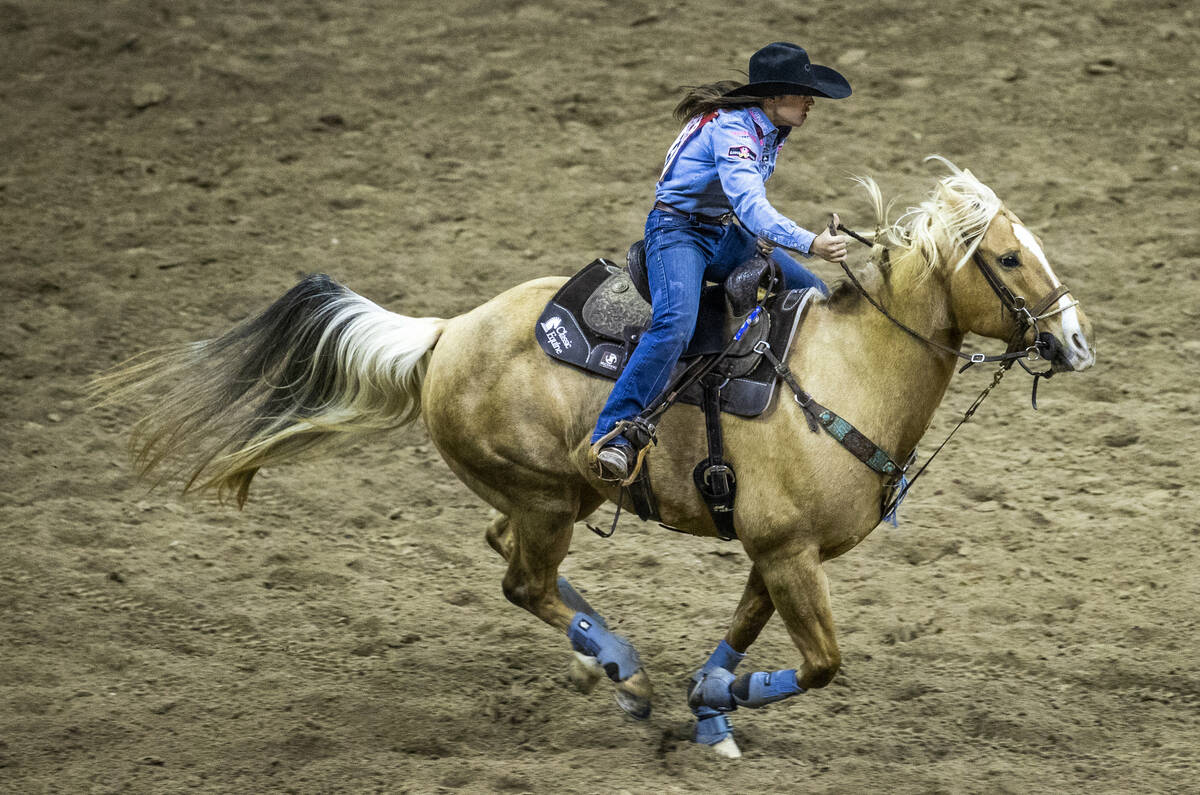 Hailey Kinsel of Cotulla, TX, rides to the next obstacle in Barrel Racing during the opening ni ...
