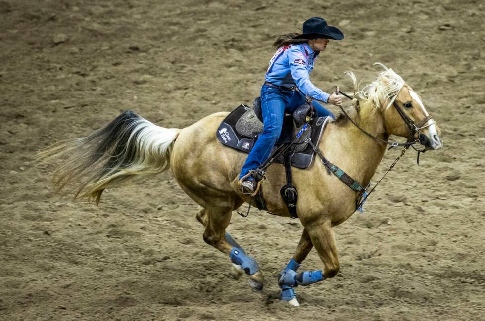 Hailey Kinsel of Cotulla, TX, rides to the next obstacle in Barrel Racing during the opening ni ...