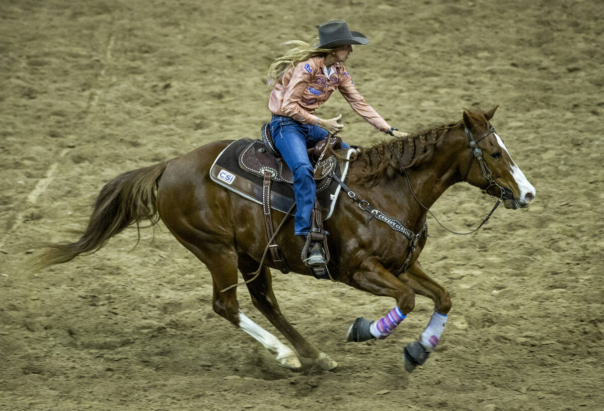 Cheyenne Wimberley of Stephenville, TX., races to the next obstacle in Barrel Racing to tie for ...