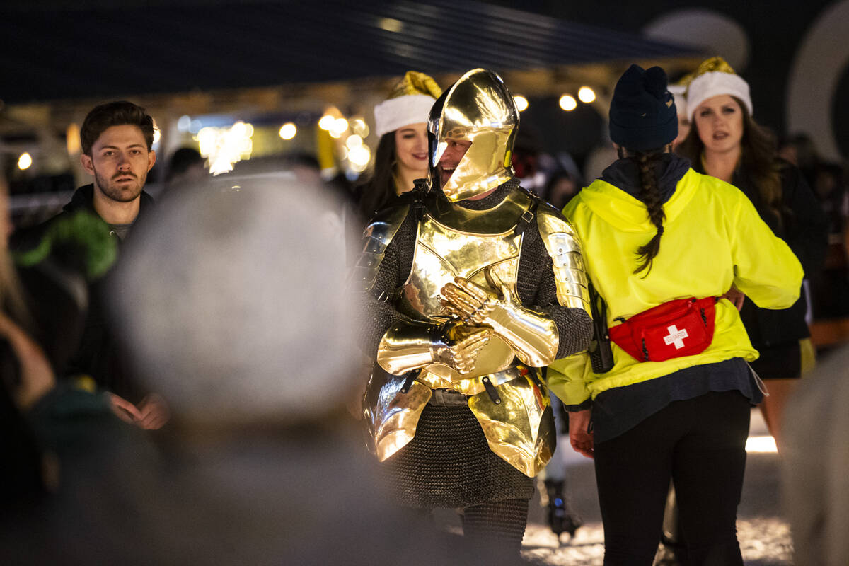 Lee Orchard, the Golden Knight, skates with attendees during the "Knight of Giving" a ...