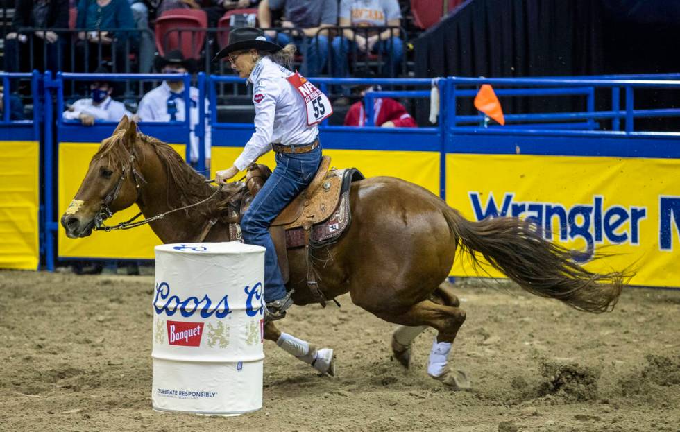 Dona Kay Rule of Minco, OK., turns a corner for home for first place in Barrel Racing during th ...