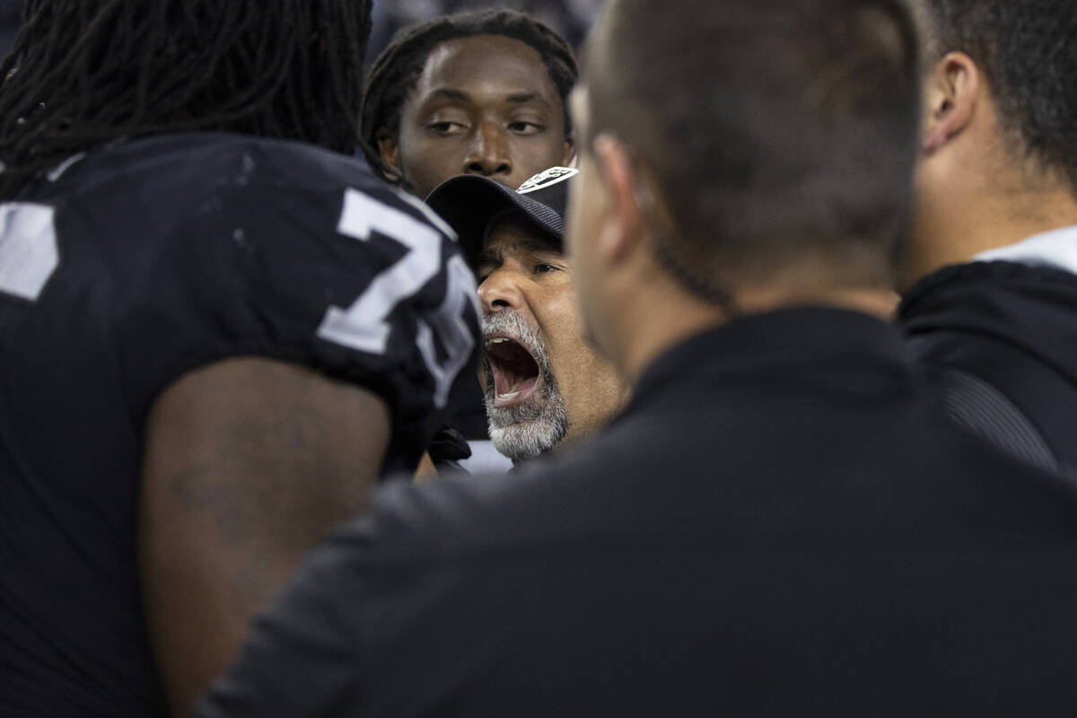 Raiders interim head coach Rich Bisaccia coaches up his team during an NFL football game agains ...
