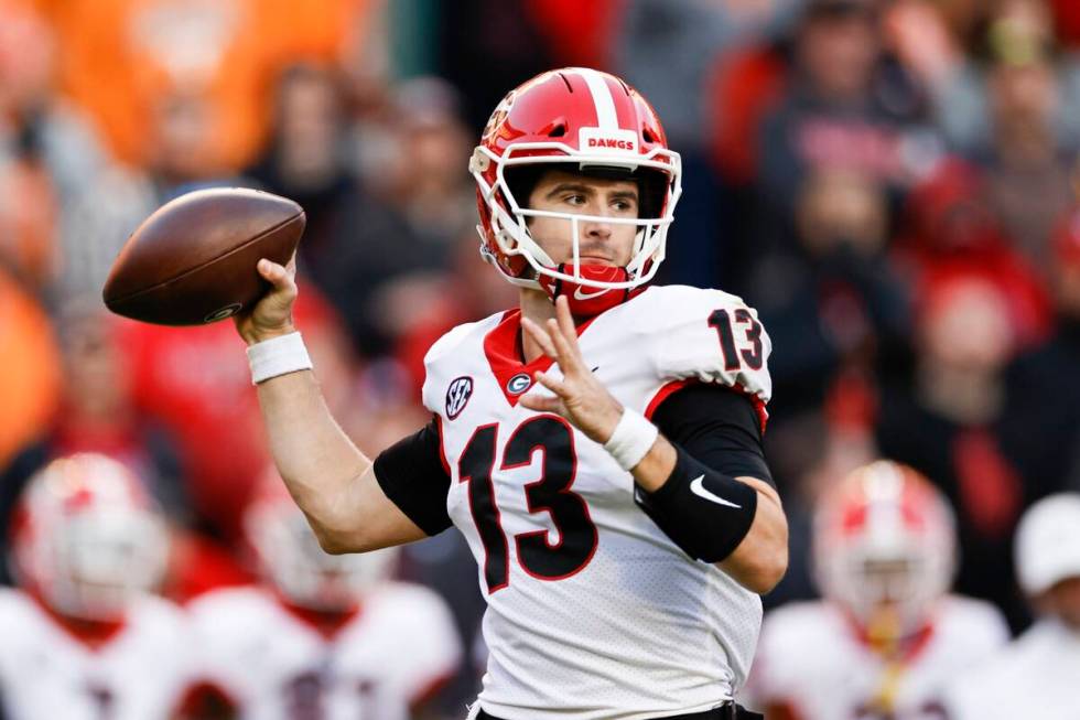Georgia quarterback Stetson Bennett (13) throws to a receiver during the first half of an NCAA ...