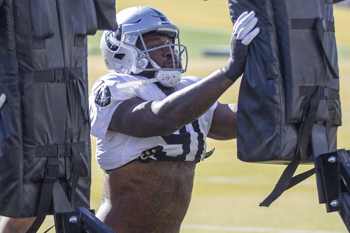 Raiders defensive end Yannick Ngakoue (91) hits the tackle post during practice at Raiders head ...