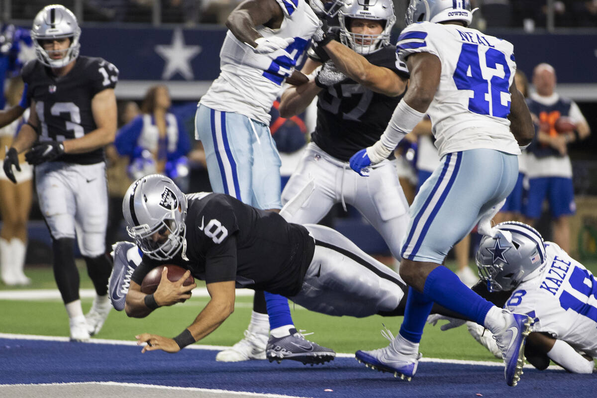 Raiders quarterback Marcus Mariota (8) leaps into the end zone past Dallas Cowboys free safety ...