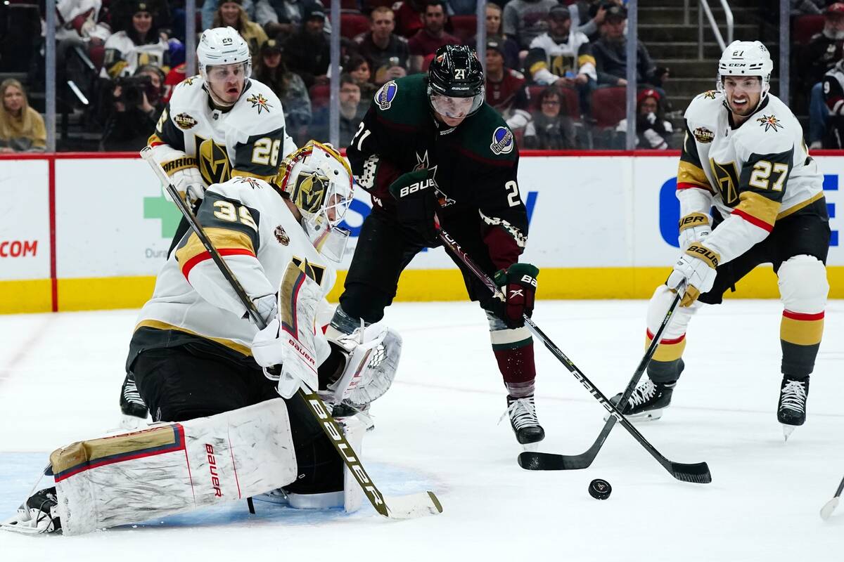 Vegas Golden Knights goalie Laurent Brossoit (39) makes a save on a shot by Arizona Coyotes lef ...