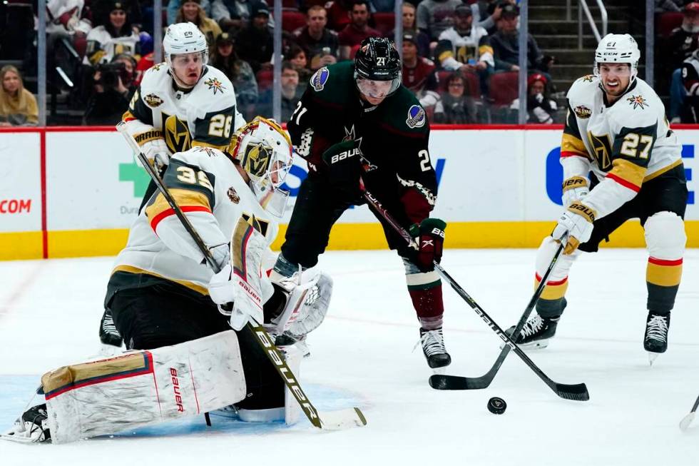 Vegas Golden Knights goalie Laurent Brossoit (39) makes a save on a shot by Arizona Coyotes lef ...