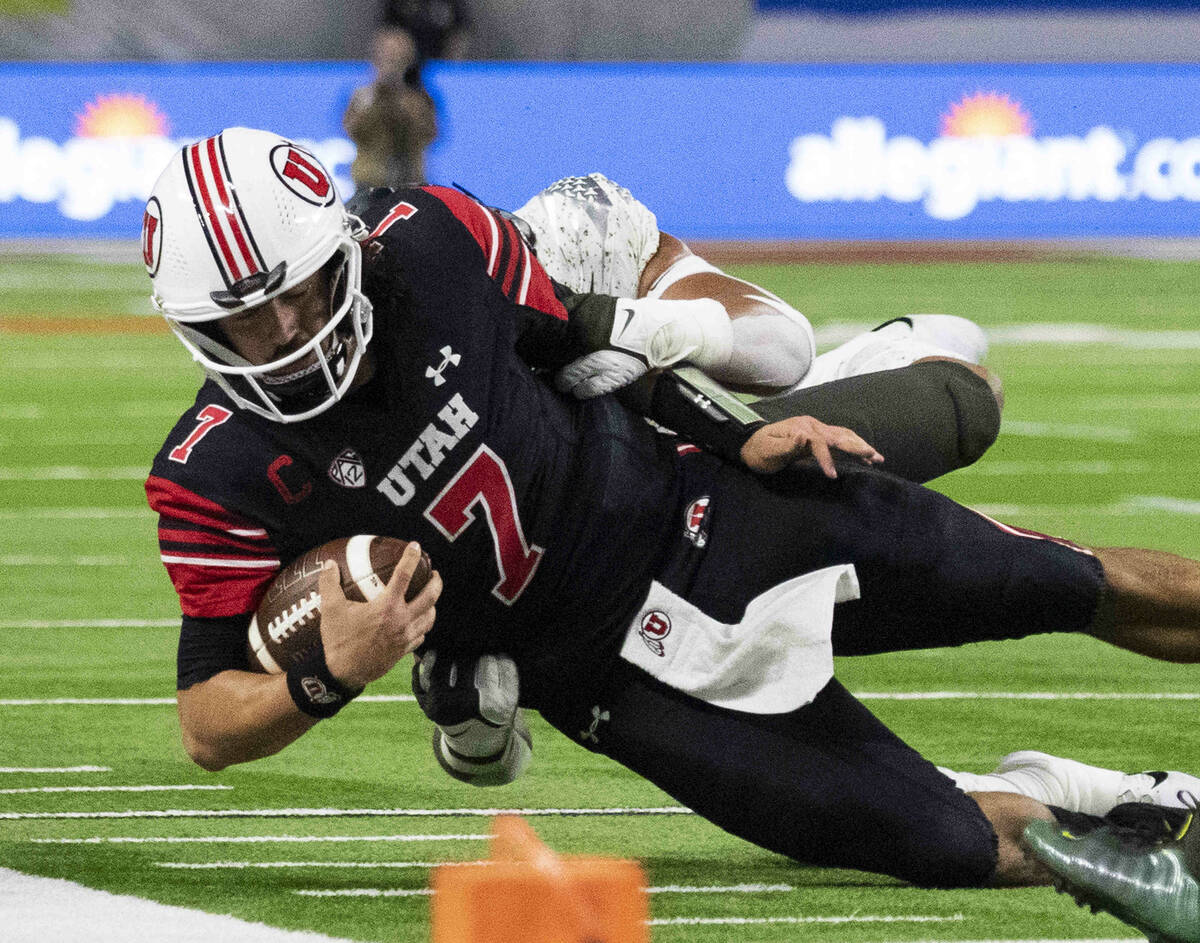 Utah Utes quarterback Cameron Rising (7) tackled by Oregon Ducks cornerback Mykael Wright (2) d ...