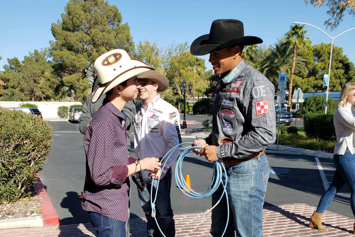 Shad Mayfield teaching Angelo Mayorga how to rope during Friday’s visit by Wrangler NFR conte ...