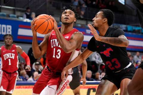 UNLV guard Bryce Hamilton (13) drives to the basket for a shot as SMU guard Michael Weathers (2 ...