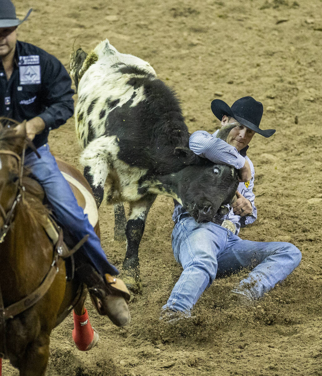 Tristan Martin of Sulphur, Louisiana, grabs his animal in Steer Wrestling for first place durin ...