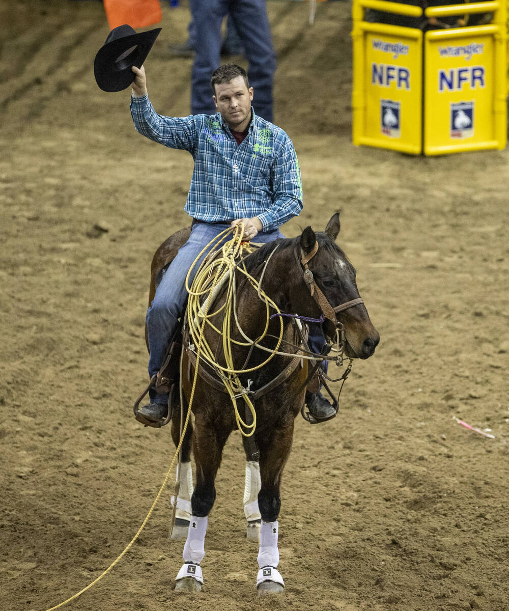 Caleb Smidt of Bellville, Texas, thanks the fans after taking first place in Tie-Down Roping du ...